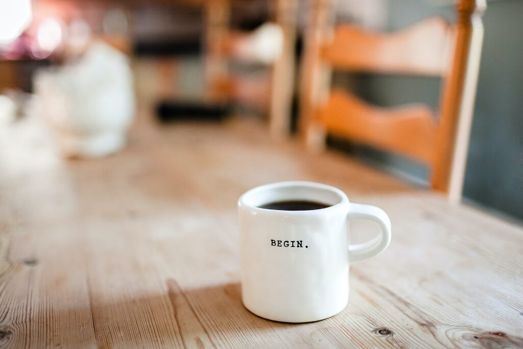white coffee mug on the wooden table. the article is about tips for budding entrepreneurs